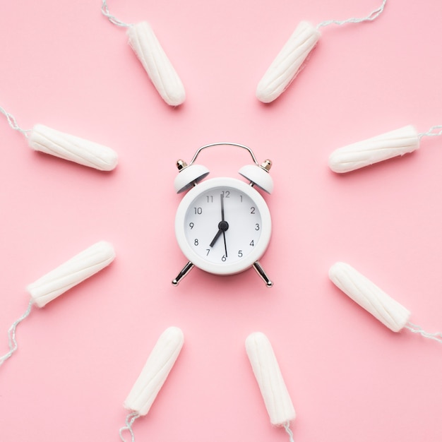 Alarm clock surrounded by tampons