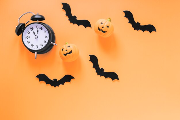 Alarm clock with paper bats and pumpkins