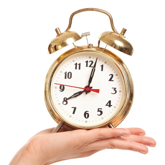 Free photo alarm clock in woman's hand