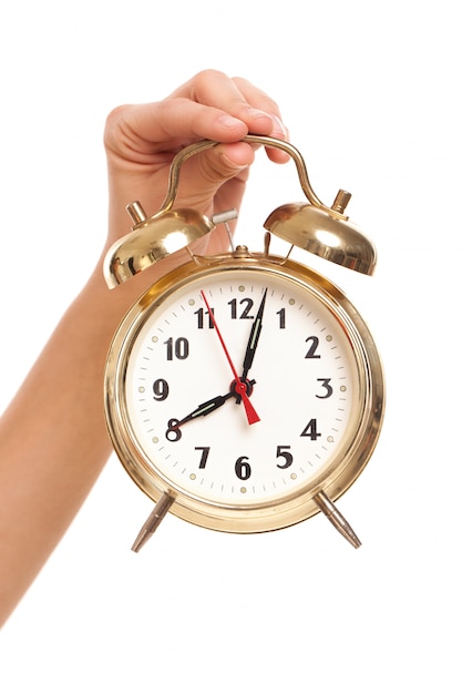 Alarm clock in woman's hand