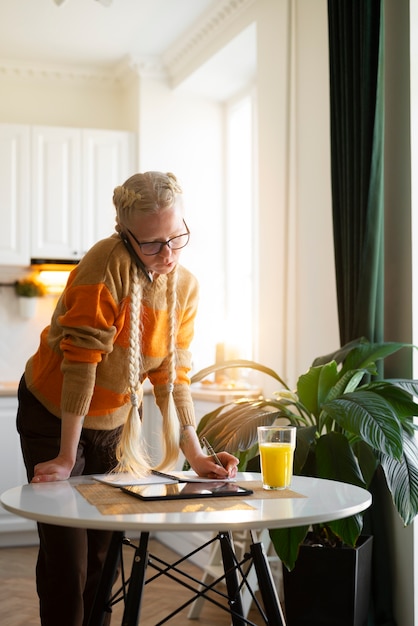 Free photo albino person at home doing activities