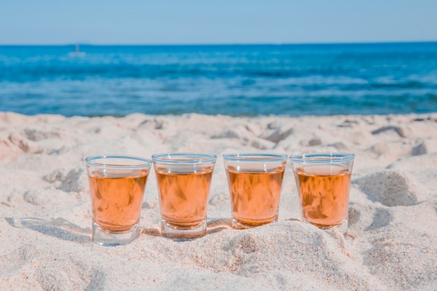 Free photo alcohol shots on sandy beach