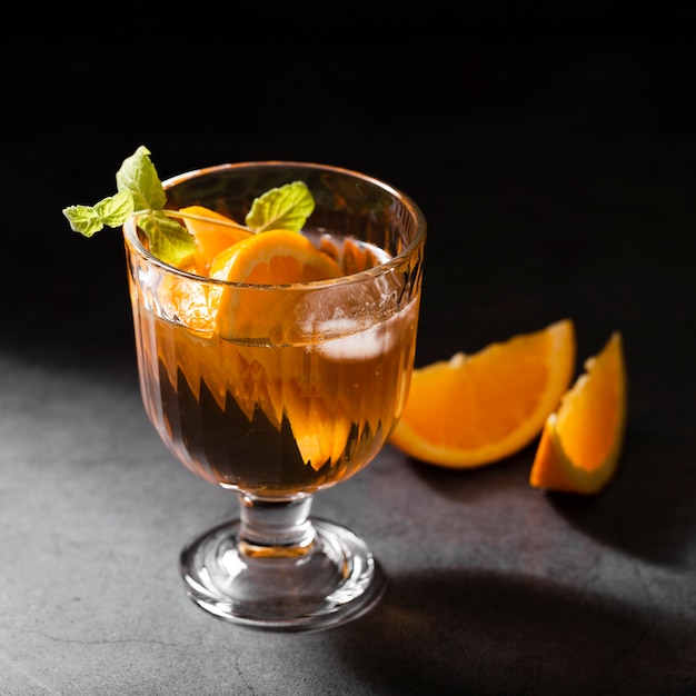 Alcoholic cocktail with oranges close up