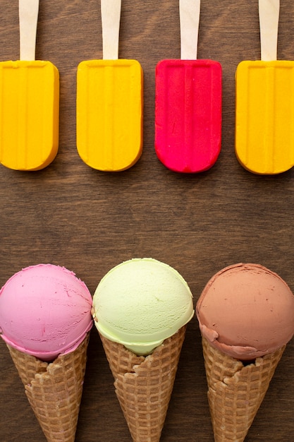 Aligned ice cream on sticks and cones