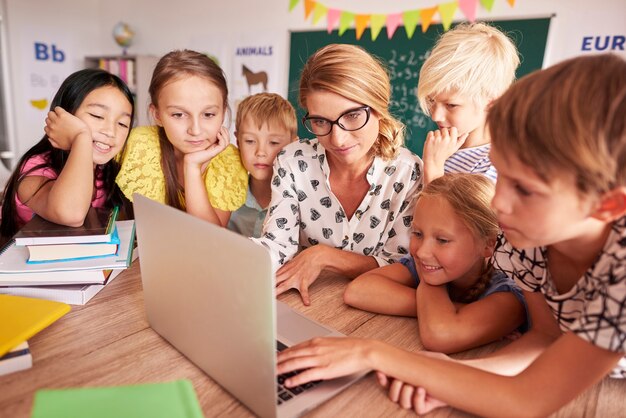 All students around one laptop