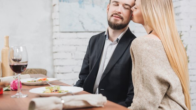 Alluring sensual couple at dinner table