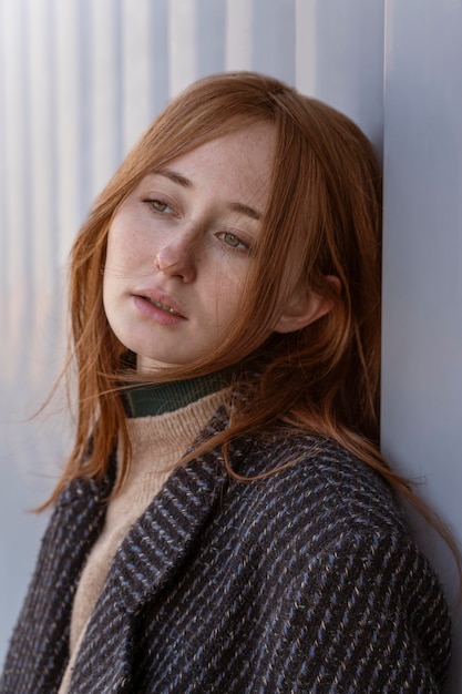 Alluring woman posing against wall