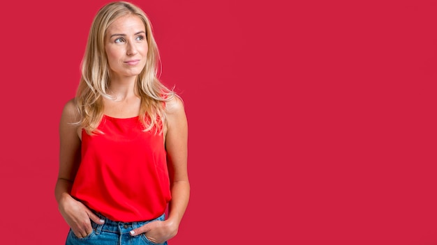 Alluring woman posing in red tank top with copy space