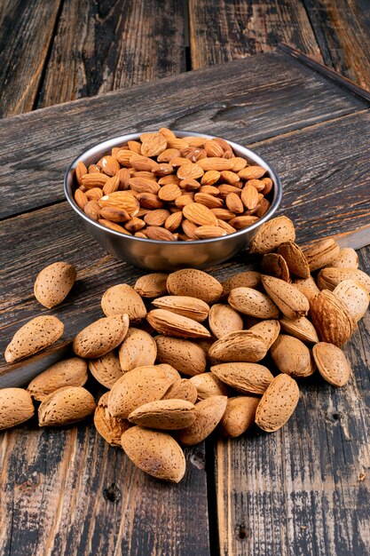 Almond in a iron bowl high angle view on a dark wooden table