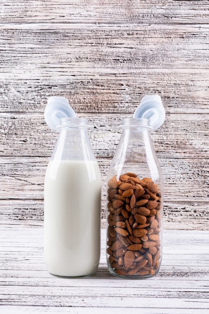 Free photo almond and milk in a bottles side view