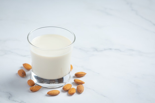 Бесплатное фото Миндальное молоко с миндалем на мраморном фоне