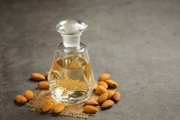 Almond oil in bottle on dark background