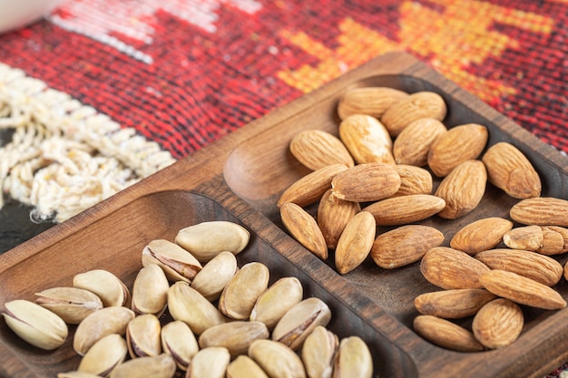 Almond and pistachios in a wooden platter