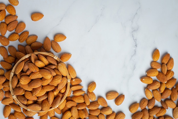Free photo almonds in bowl on marble background