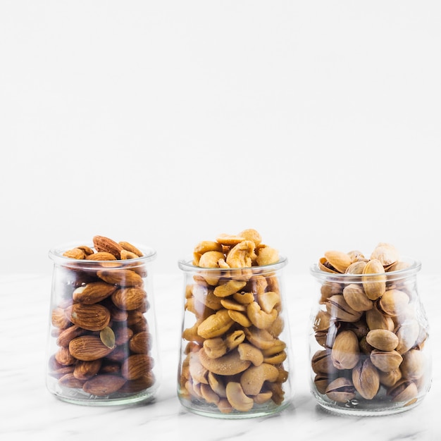 Almonds; cashewnuts and pistachios on marble backdrop
