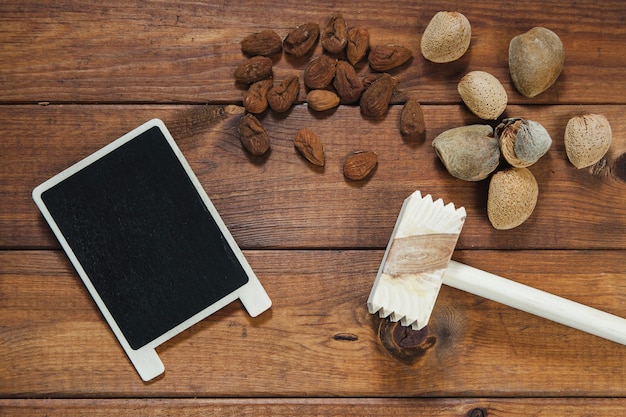 Almonds, steak hammer and blackboard