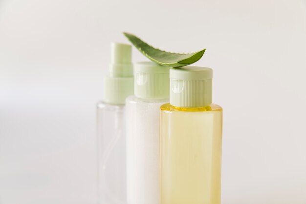 Aloe Vera over the spray bottles on white background