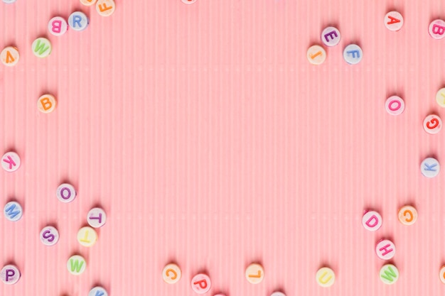 Alphabet beads border pink wallpaper background text space