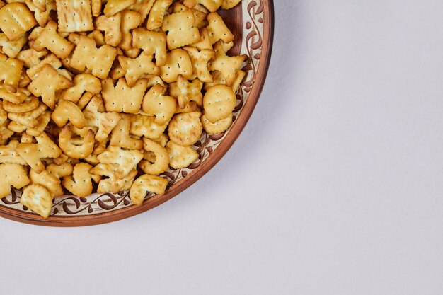 Alphabet crackers on ceramic plate.