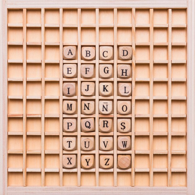 Alphabet with dice on wooden board