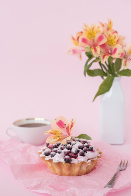 Alstroemeria flower on fruit tart consisting of blueberries