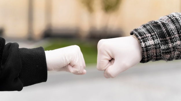 Free photo alternative greetings almost touching fist bumps with gloves