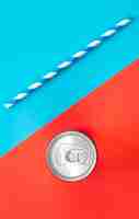 Free photo aluminum drink or beverage can with pull ring on colored background flat lay