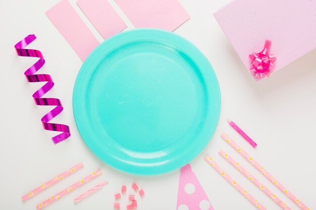 Am empty plate with decorative items and gifts on white background