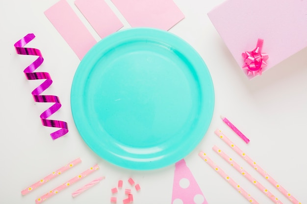 Am empty plate with decorative items and gifts on white background