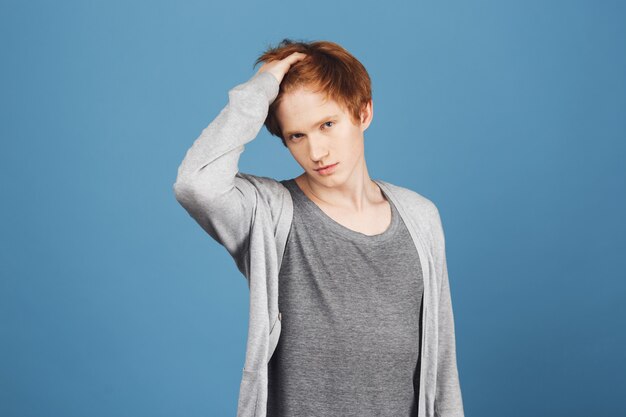 Am I beautiful and gorgeous enough, girl Portrait of self-confident young ginger teenager in casual outfit touching hair with hand,  with flirty and narcissistic expression.