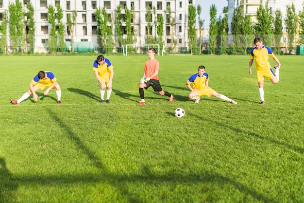 Amateur football concept with team stretching