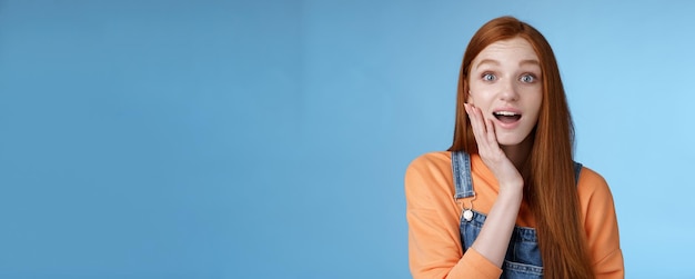 Free photo amazed friendly sensitive impressed redhead girl learn awesome pleasant news open mouth wondered