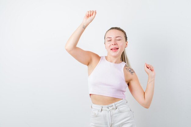 Amazed girl is dancing on white background