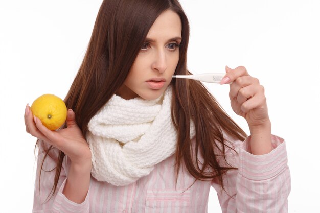 Amazed girl looking at a thermometer