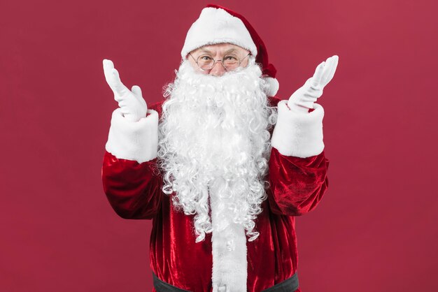 Amazed Santa Claus in glasses with hands up