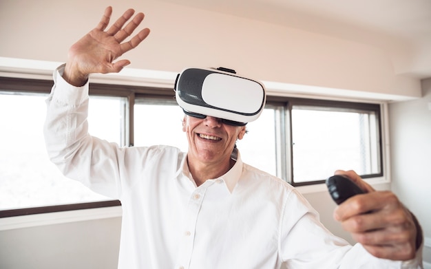 Amazed senior man touching in the air during the vr experience