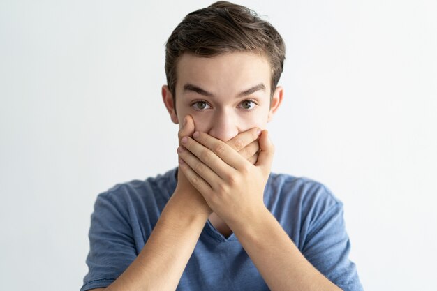 Amazed teenage guy getting shocking disbelieving news