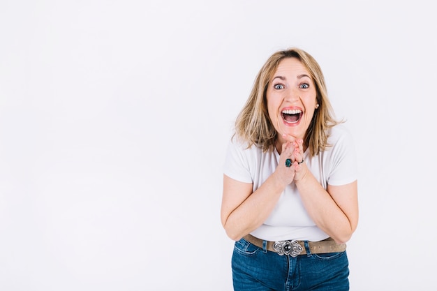 Free photo amazed woman clasping hands