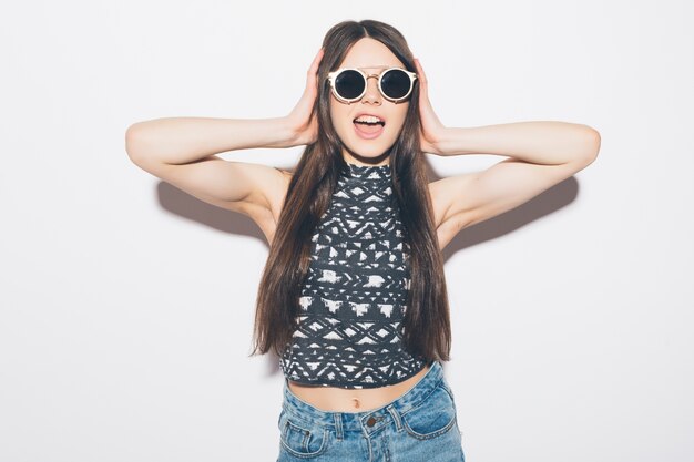 Amazed woman looking isolated on a white wall