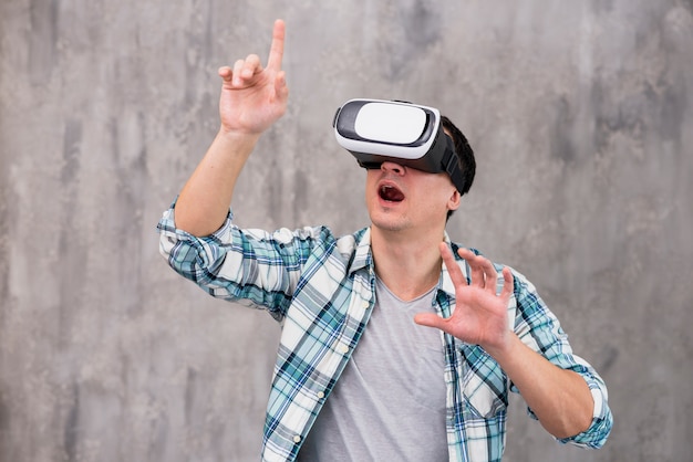 Amazed young man in VR headset