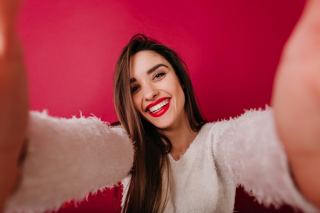 Amazing girl in fluffy sweater expressing happiness