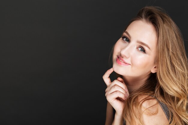 Amazing lady posing over dark wall