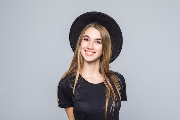 Amazing lady with gold hair dressed up in black with retro hat smiles isolated on background