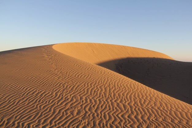 Amazing shot of a desert dune on blue sky