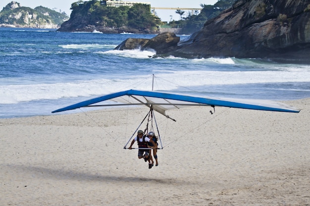 Free photo amazing shot of human trying to fly on a hang glider