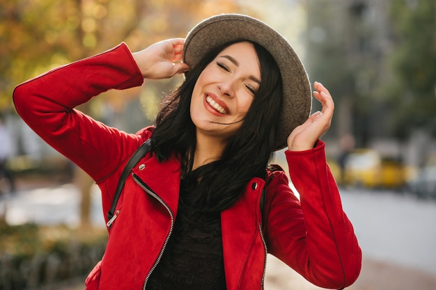 Amazing white woman laughing with eyes closed on nature wall