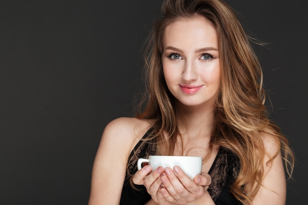 Amazing woman holding cup of coffee