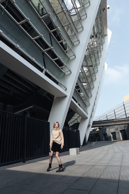 Amazing young blonde lady walking outdoors.