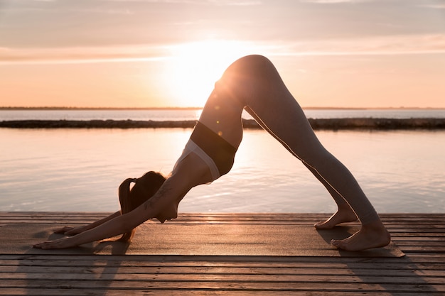 Amazing young sports lady make yoga exercises.