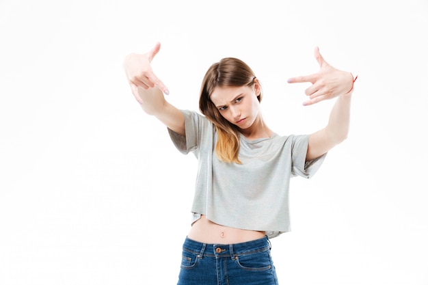 Amazing young woman showing rock gesture.